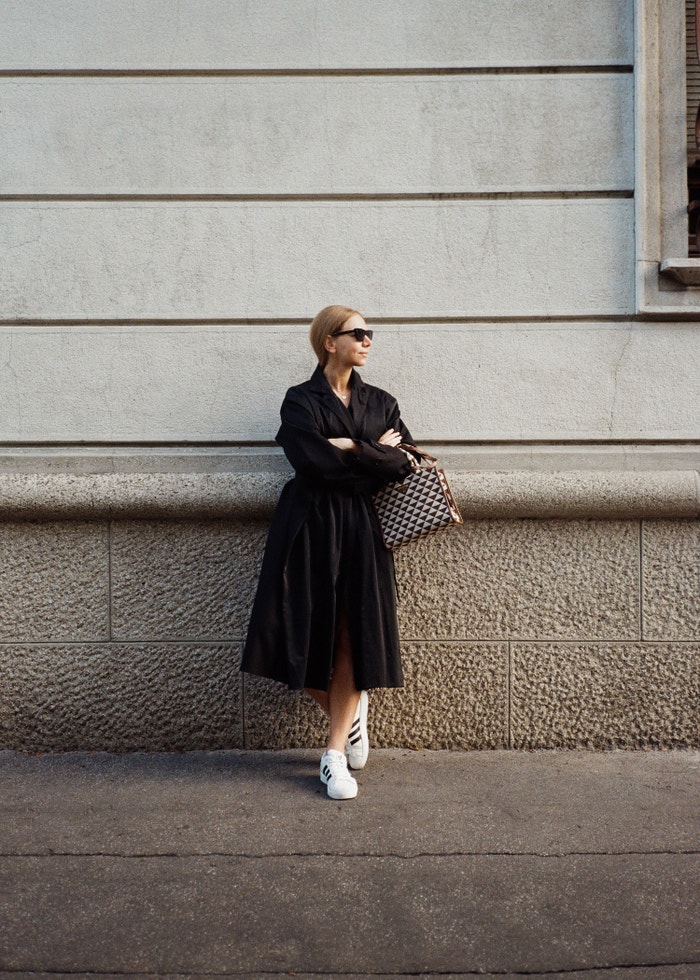 Kabát LITKOVSKA prodává Symbols, kabelka PRADA, boty ADIDAS Superstar