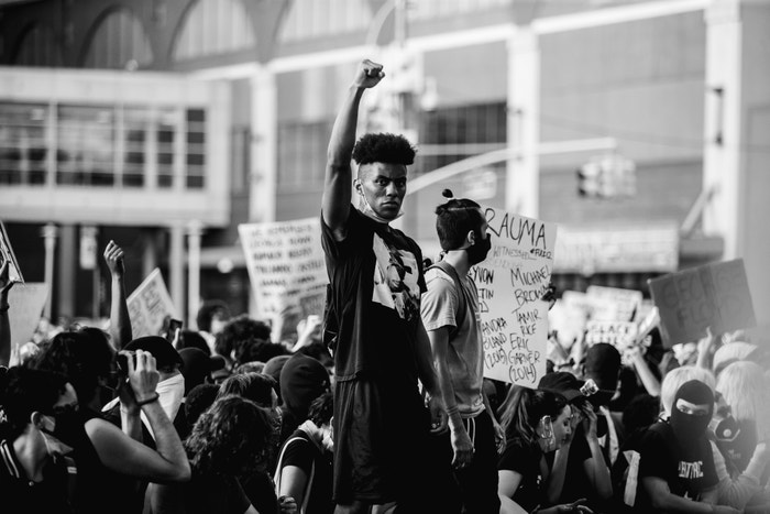 30 May 2020. A young black man raises his fist to show solidarity with the other black protesters in the protest at the Barclays Center, Brooklyn, New York.