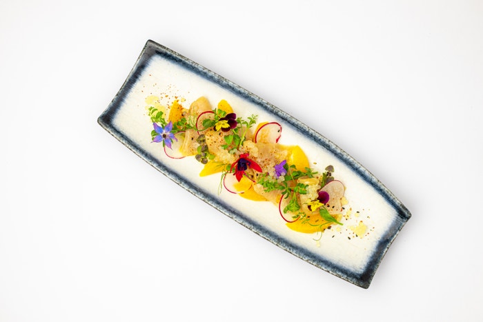 Tenké plátky sashimi z japonského kranase, ke kterému se přidává domácí limetkový kaviár, čerstvý pomeranč, pomerančový olej, ředkvičky a nakonec mořská maldonská sůl. Autor: Archiv Buddha Baru
