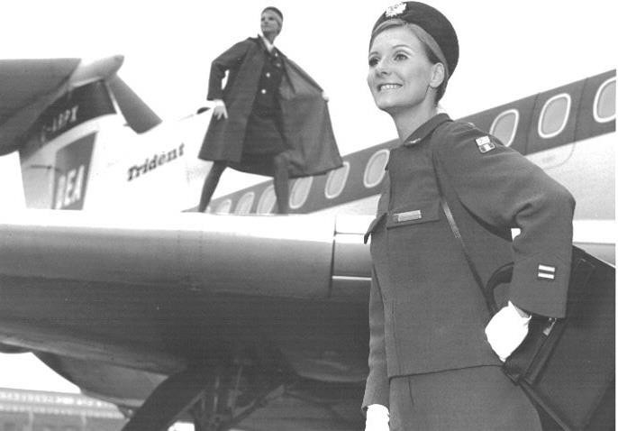 V roce 1967 představily BEA další novou uniformu vyrobenou z terylénu v královské modři a česané příze, která pro zaměstnankyně aerolinek představovala v době proudových letounů nový módní směr. Styl této uniformy s kratší sukní odráží trendy doby. Červený svrchní kabátek poskytoval brilantní barevné prvky, které ladily s červenými křídly nového barevného provedení letadel a červeným čtvercovým logem BEA. Uniformu navrhl Hardy Amies, který svou kariéru začal jako krejčí. Byl jedním z nejslavnějších britských návrhářů s mezinárodním věhlasem v oblasti dámského i pánského oblečení. Byl krejčím Její královské Výsosti princezny Alžběty, nyní královny Alžběty II. Autor: archiv British Airways
