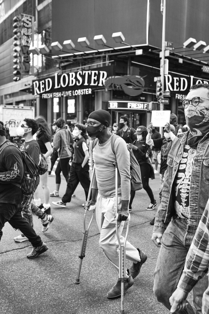 31 May 2020. A man on crutches marches in New York for George Floyd.